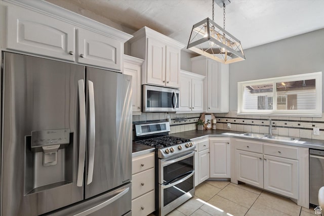 754 E 500 S, Provo, UT 84606 - kitchen featuring stainless steel appliances, white cabinetry, decorative backsplash, and light tile patterned floors