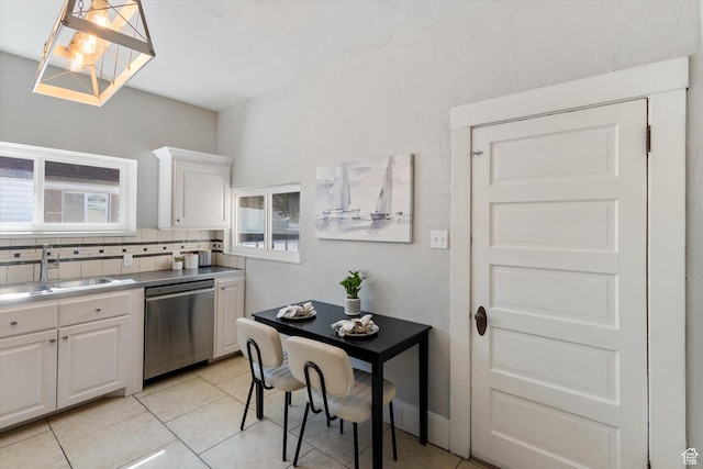 754 E 500 S, Provo, UT 84606 - kitchen featuring stainless steel dishwasher, white cabinets, light tile patterned flooring, and tasteful backsplash