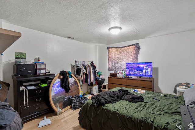 8168 S Darin St, Midvale, UT 84047 - bedroom with wood finished floors and a textured ceiling