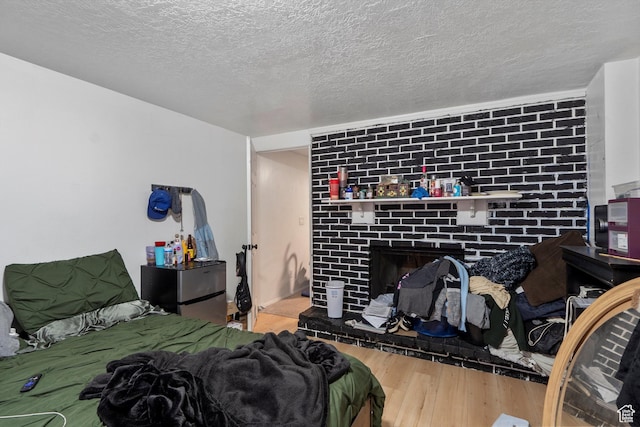 8168 S Darin St, Midvale, UT 84047 - bedroom with wood finished floors, a fireplace, and a textured ceiling