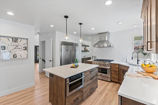 692 E Country Breeze Cir S, Draper, UT 84020 - kitchen with wall chimney exhaust hood, premium appliances, light wood finished floors, light countertops, and recessed lighting
