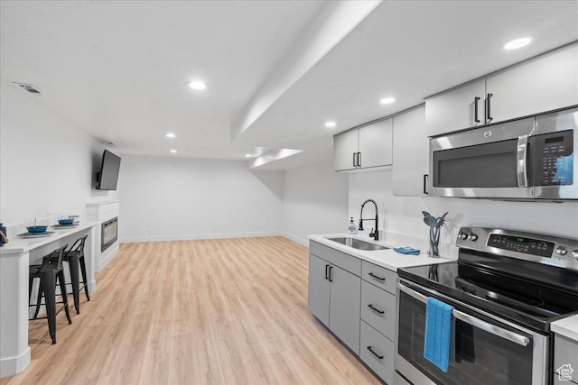 692 E Country Breeze Cir S, Draper, UT 84020 - kitchen with stainless steel appliances, light wood-type flooring, recessed lighting, light countertops, and open floor plan
