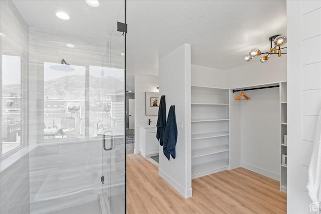 692 E Country Breeze Cir S, Draper, UT 84020 - full bath featuring a stall shower, a spacious closet, wood finished floors, a chandelier, and recessed lighting
