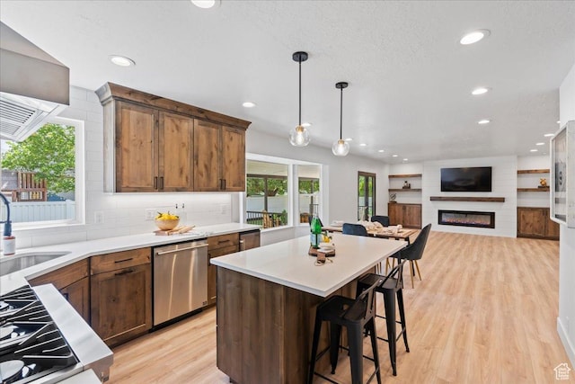 692 E Country Breeze Cir S, Draper, UT 84020 - kitchen with stainless steel dishwasher, light wood-style floors, light countertops, recessed lighting, and decorative light fixtures