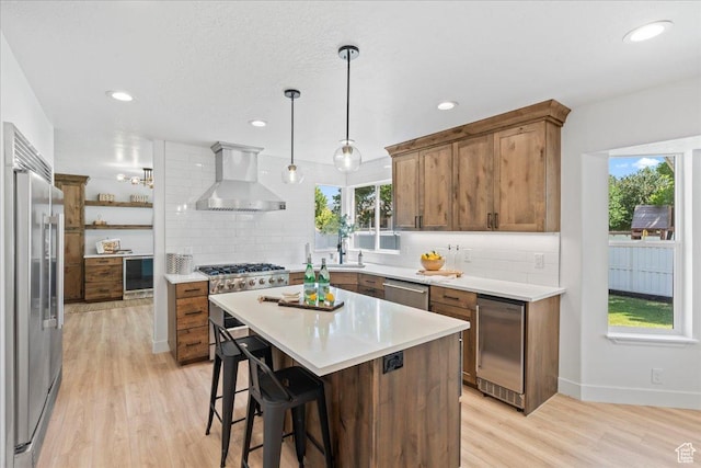 692 E Country Breeze Cir S, Draper, UT 84020 - kitchen featuring wall chimney range hood, wine cooler, stainless steel appliances, decorative backsplash, and recessed lighting