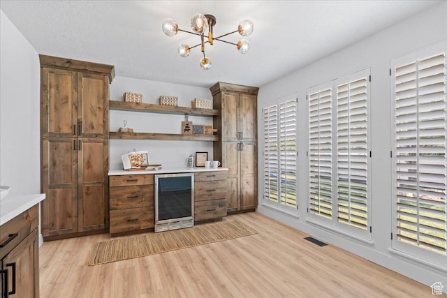 692 E Country Breeze Cir S, Draper, UT 84020 - indoor dry bar featuring beverage cooler, light wood finished floors, and a chandelier