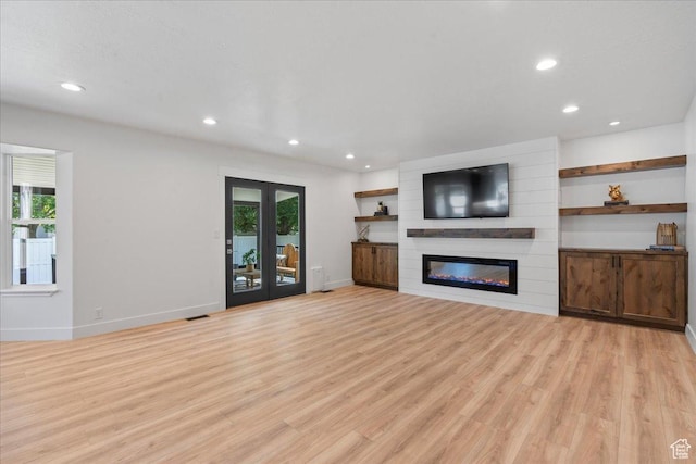 692 E Country Breeze Cir S, Draper, UT 84020 - unfurnished living room featuring healthy amount of natural light, recessed lighting, light wood-style flooring, and a large fireplace
