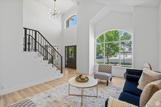 692 E Country Breeze Cir S, Draper, UT 84020 - living room with high vaulted ceiling, a chandelier, wood finished floors, and stairway