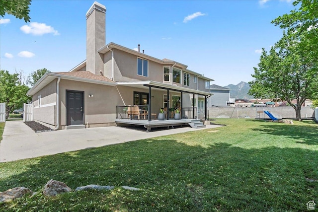 692 E Country Breeze Cir S, Draper, UT 84020 - back of house with stucco siding, a playground, a patio area, a chimney, and a deck