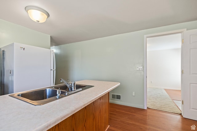 890 E Monroe Canyon Rd S, Monroe, UT 84754 - kitchen featuring freestanding refrigerator, wood finished floors, and light countertops