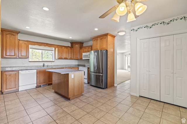 890 E Monroe Canyon Rd S, Monroe, UT 84754 - kitchen with white appliances, a kitchen island, light tile patterned floors, recessed lighting, and ceiling fan