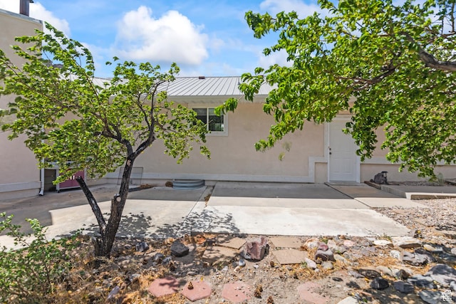 890 E Monroe Canyon Rd S, Monroe, UT 84754 - rear view of property featuring a patio area, stucco siding, a metal roof, and a standing seam roof