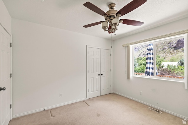 890 E Monroe Canyon Rd S, Monroe, UT 84754 - unfurnished bedroom featuring light colored carpet, a closet, and a ceiling fan