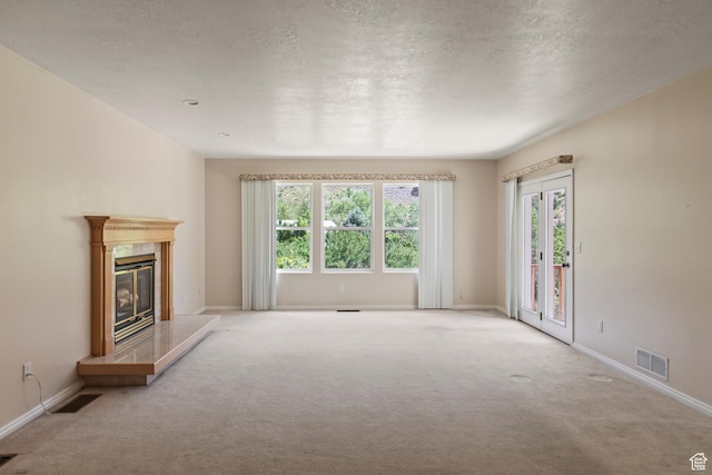 890 E Monroe Canyon Rd S, Monroe, UT 84754 - unfurnished living room with carpet floors, a fireplace, and a textured ceiling
