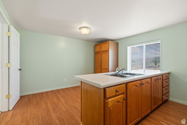 890 E Monroe Canyon Rd S, Monroe, UT 84754 - kitchen featuring light wood-style flooring, light countertops, brown cabinets, and a peninsula