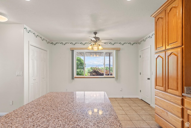 890 E Monroe Canyon Rd S, Monroe, UT 84754 - kitchen with ceiling fan, light stone countertops, and light tile patterned floors