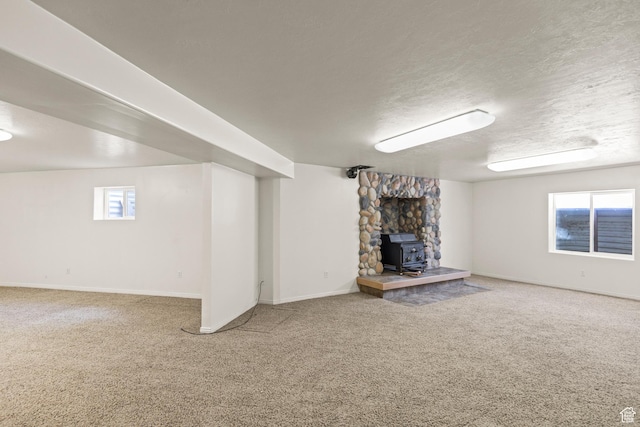 890 E Monroe Canyon Rd S, Monroe, UT 84754 - unfurnished living room with a wood stove, carpet flooring, and a textured ceiling