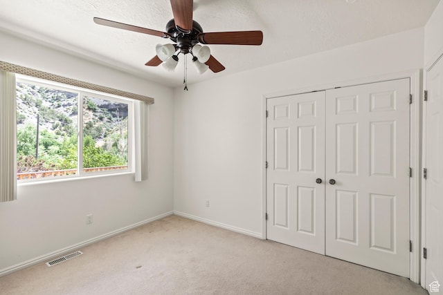 890 E Monroe Canyon Rd S, Monroe, UT 84754 - unfurnished bedroom featuring light carpet, a closet, and ceiling fan