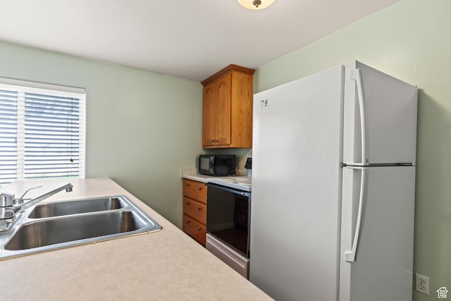 890 E Monroe Canyon Rd S, Monroe, UT 84754 - kitchen featuring freestanding refrigerator, black microwave, range with electric cooktop, light countertops, and brown cabinets