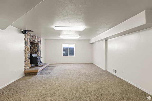 890 E Monroe Canyon Rd S, Monroe, UT 84754 - unfurnished living room featuring a wood stove and carpet floors