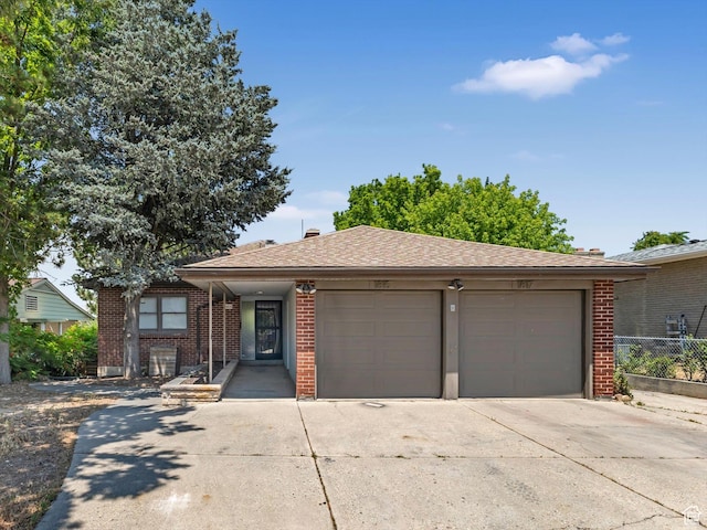 1815 E Hillcrest Ave, Salt Lake City, UT 84106 - view of front of house with brick siding, driveway, an attached garage, and roof with shingles