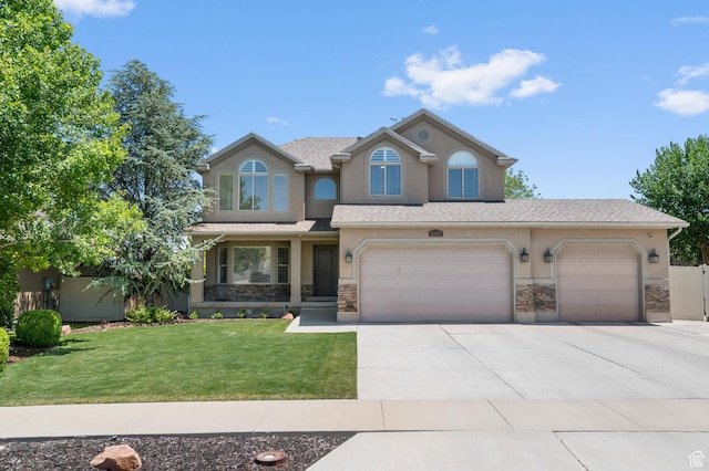 12363 S 3825 W, Riverton, UT 84065 - view of front of house featuring stucco siding, concrete driveway, stone siding, a front yard, and an attached garage