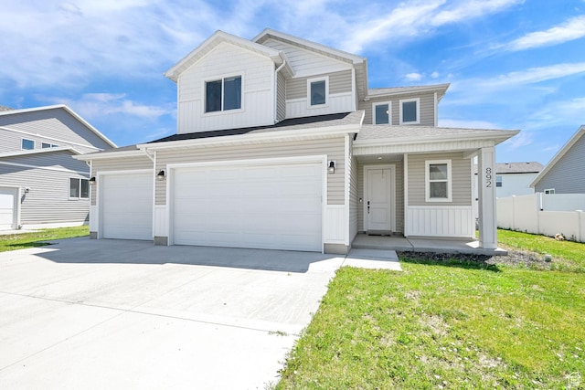 892 N 900 W, Tremonton, UT 84337 - view of front of house featuring a porch, driveway, board and batten siding, and a garage