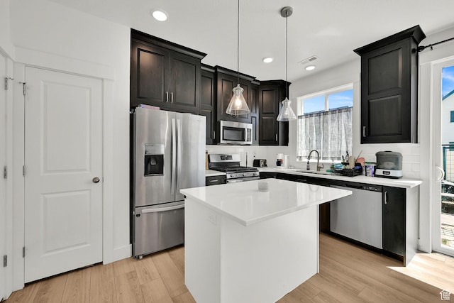 892 N 900 W, Tremonton, UT 84337 - kitchen featuring appliances with stainless steel finishes, a center island, light wood-style floors, light countertops, and recessed lighting