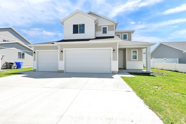 892 N 900 W, Tremonton, UT 84337 - view of front of home with concrete driveway, board and batten siding, an attached garage, and a porch