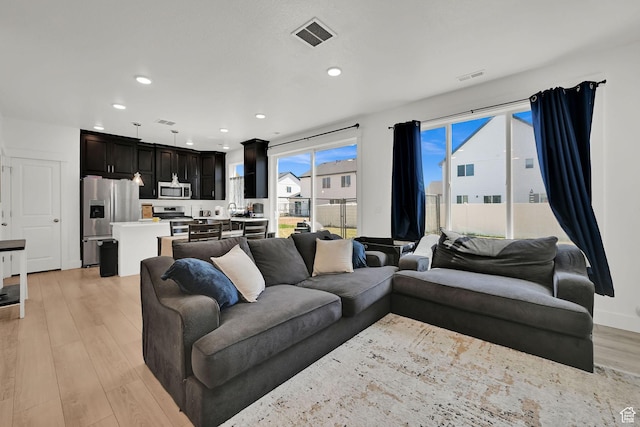 892 N 900 W, Tremonton, UT 84337 - living room featuring light wood-style flooring and recessed lighting