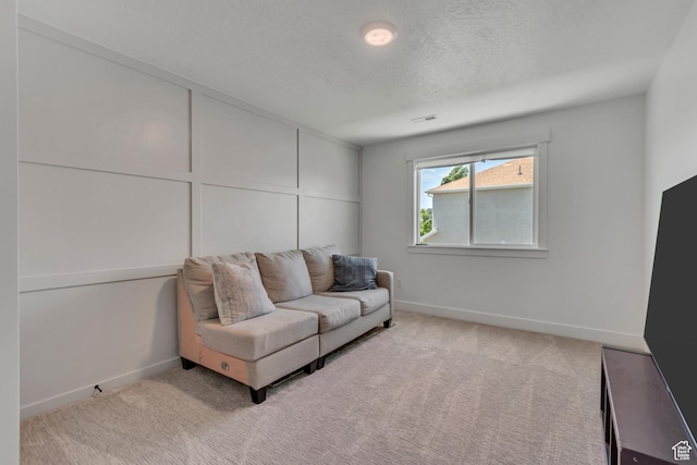 10948 S Samoa Dune Dr Unit 1027, South Jordan, UT 84009 - carpeted living room featuring baseboards and a textured ceiling