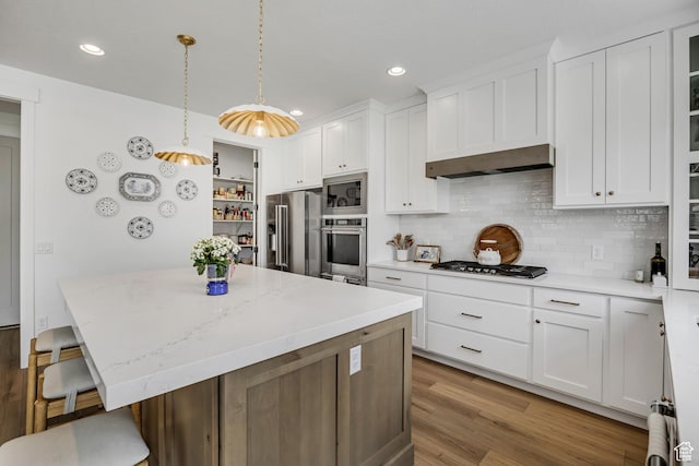 10948 S Samoa Dune Dr Unit 1027, South Jordan, UT 84009 - kitchen with stainless steel appliances, a kitchen island, white cabinetry, backsplash, and recessed lighting