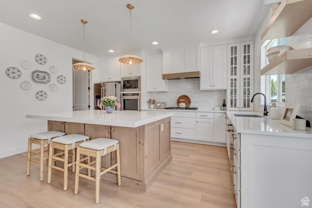 10948 S Samoa Dune Dr Unit 1027, South Jordan, UT 84009 - kitchen with appliances with stainless steel finishes, light wood-style floors, decorative backsplash, a center island, and recessed lighting