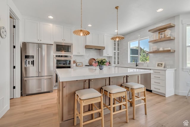 10948 S Samoa Dune Dr Unit 1027, South Jordan, UT 84009 - kitchen with appliances with stainless steel finishes, tasteful backsplash, light wood-type flooring, white cabinets, and recessed lighting