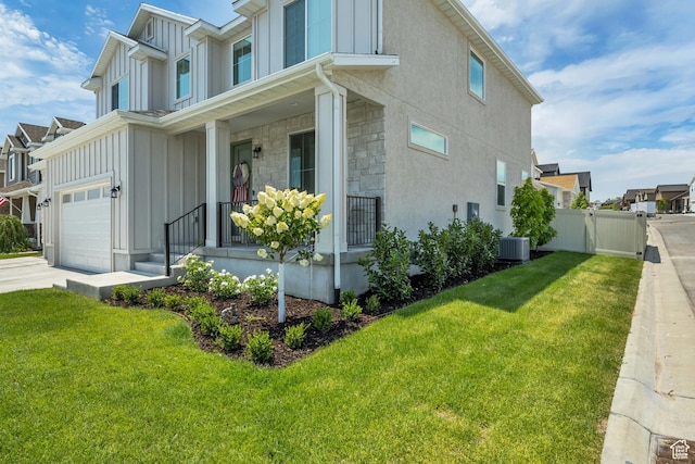 10948 S Samoa Dune Dr Unit 1027, South Jordan, UT 84009 - view of side of property featuring board and batten siding, covered porch, stone siding, and driveway