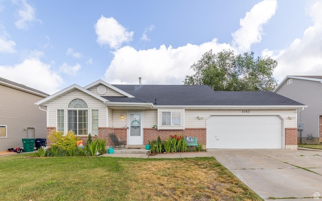 3762 W 4700 S, Roy, UT 84067 - view of front of house with brick siding, driveway, a garage, and a front yard