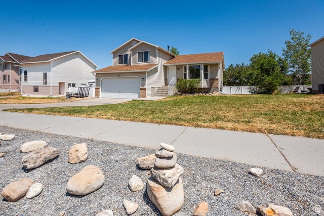 494 W 600 S, Tooele, UT 84074 - tri-level home with driveway, a garage, and brick siding