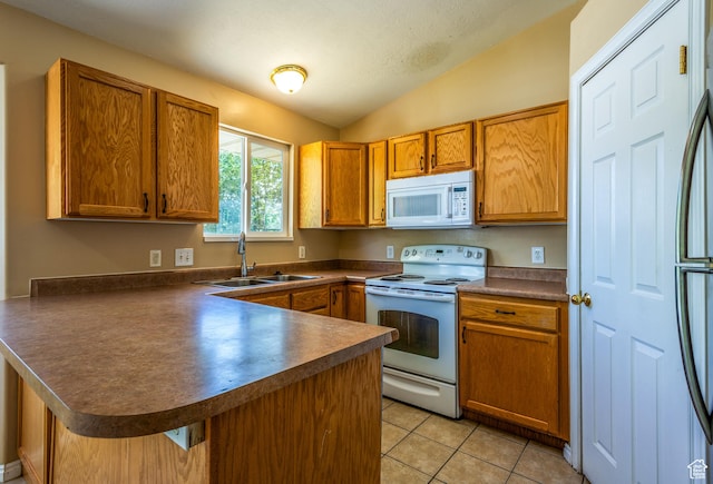 494 W 600 S, Tooele, UT 84074 - kitchen with white appliances, a peninsula, dark countertops, vaulted ceiling, and brown cabinets
