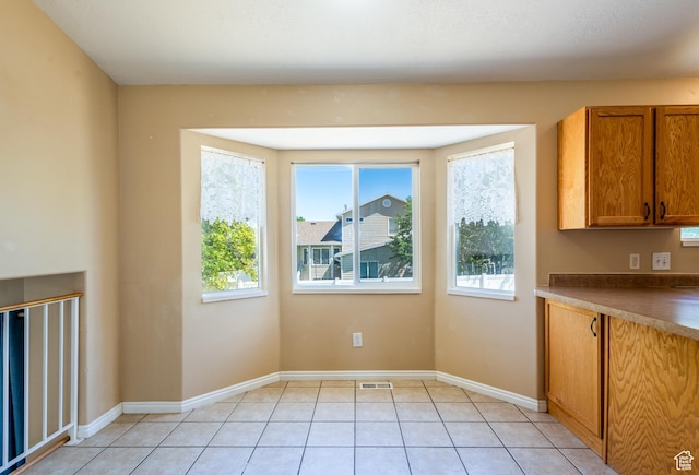 494 W 600 S, Tooele, UT 84074 - unfurnished dining area with healthy amount of natural light and light tile patterned flooring