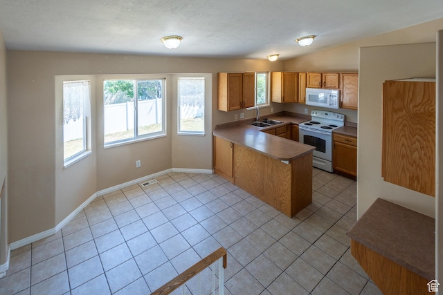 494 W 600 S, Tooele, UT 84074 - kitchen with white appliances, a peninsula, light tile patterned floors, brown cabinets, and lofted ceiling