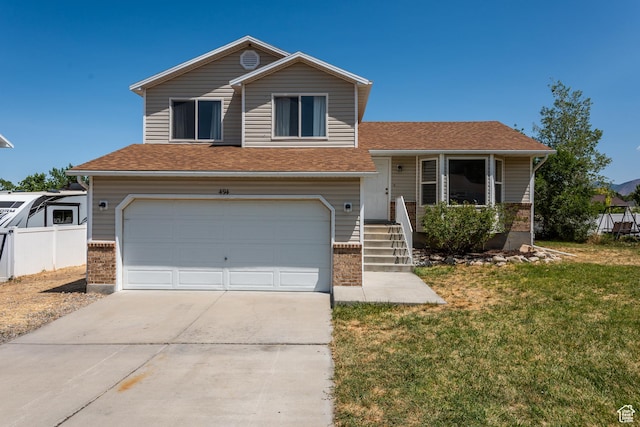 494 W 600 S, Tooele, UT 84074 - tri-level home with a garage, driveway, and roof with shingles