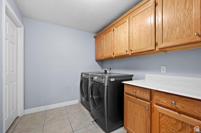 5155 S Alvera Dr E, Holladay, UT 84117 - laundry area with washing machine and dryer, cabinet space, and light tile patterned flooring