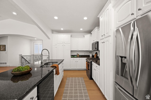 5155 S Alvera Dr E, Holladay, UT 84117 - kitchen featuring stainless steel appliances, white cabinets, arched walkways, light wood-type flooring, and recessed lighting