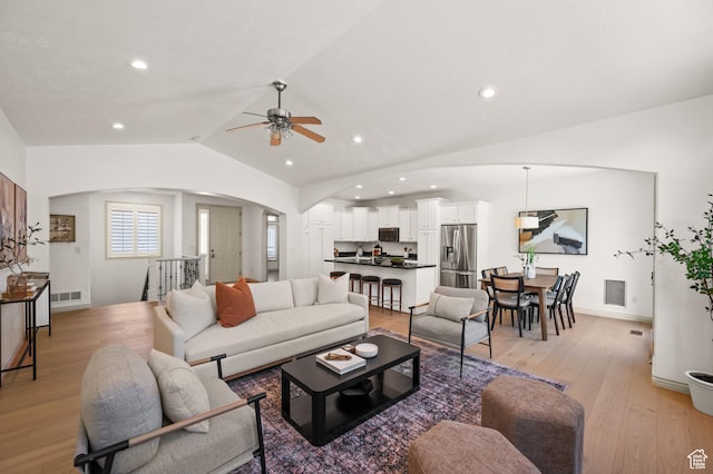 5155 S Alvera Dr E, Holladay, UT 84117 - living room with arched walkways, a ceiling fan, lofted ceiling, light wood-style flooring, and recessed lighting