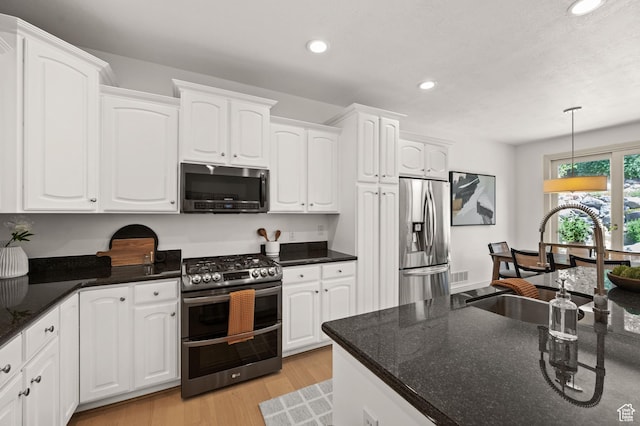 5155 S Alvera Dr E, Holladay, UT 84117 - kitchen featuring stainless steel appliances, recessed lighting, white cabinetry, pendant lighting, and light wood-style flooring