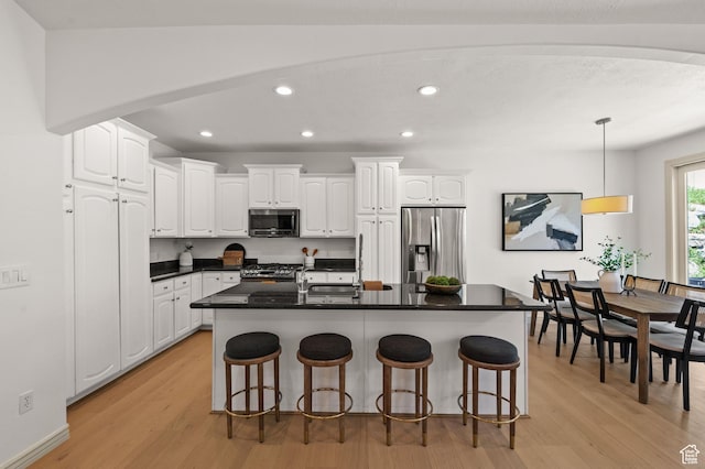 5155 S Alvera Dr E, Holladay, UT 84117 - kitchen with stainless steel appliances, light wood-type flooring, white cabinetry, dark countertops, and recessed lighting
