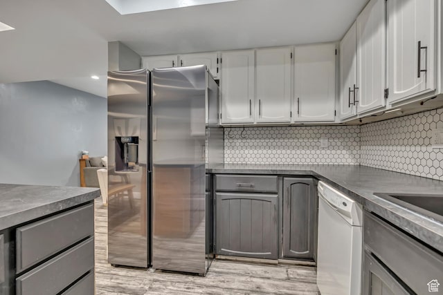 4851 S Woodbridge Dr Unit 38, Holladay, UT 84117 - kitchen featuring dishwasher, stainless steel refrigerator with ice dispenser, dark countertops, tasteful backsplash, and recessed lighting