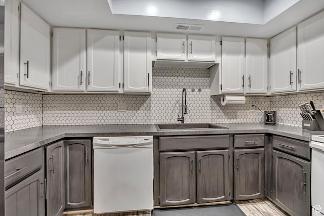 4851 S Woodbridge Dr Unit 38, Holladay, UT 84117 - kitchen with white dishwasher, backsplash, white cabinetry, and dark countertops