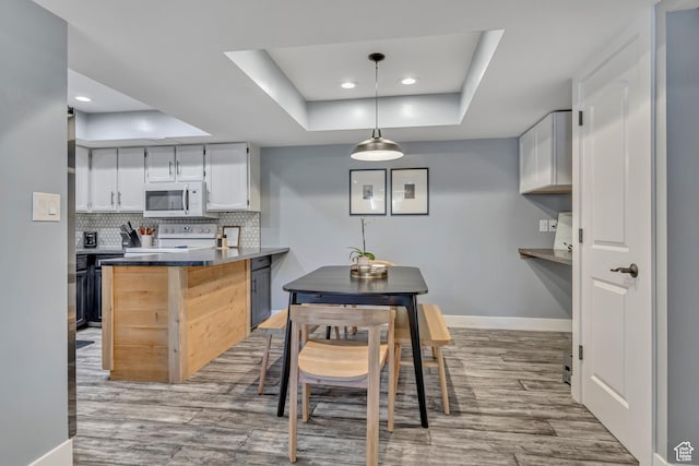 4851 S Woodbridge Dr Unit 38, Holladay, UT 84117 - dining room with a tray ceiling, light wood finished floors, and recessed lighting