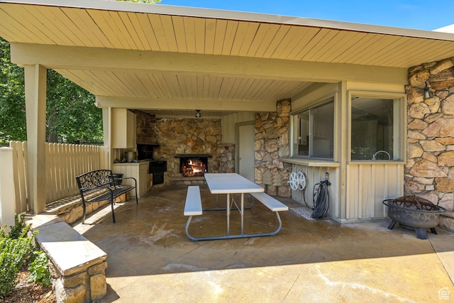4851 S Woodbridge Dr Unit 38, Holladay, UT 84117 - view of patio / terrace with an outdoor stone fireplace